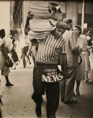 Untitled (newsboy with stack of papers)