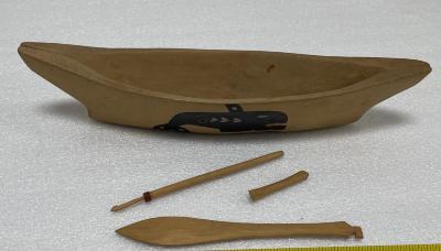 Untitled (wooden canoe, paddle, spear, and diving bar)