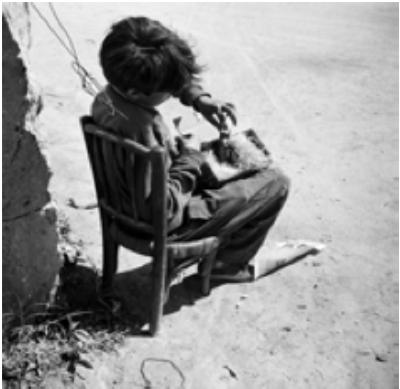 Young gypsy with found bird, Arles